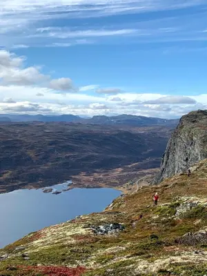 a person walking on a mountain overlooking a lake at New, Mountain paradise, biking, alpine touring, skiing in & out in Tyinkrysset