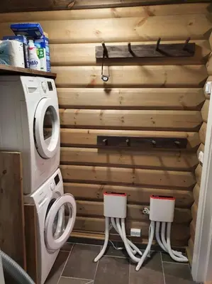 a bathroom with a washing machine and two stools at New, Mountain paradise, biking, alpine touring, skiing in & out in Tyinkrysset
