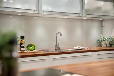 a kitchen with a sink and wooden counter top at Fløyen Lux Apartment in Bergen