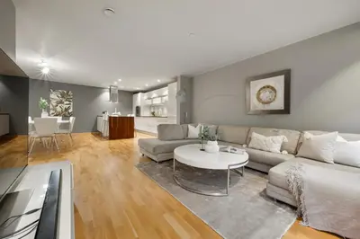 a living room with a couch and a table at Fløyen Lux Apartment in Bergen