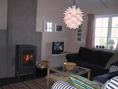 a living room with a couch and a fireplace at Gålå Fjellhytter in Gålå