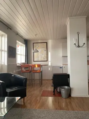 a living room with a couch and a table at Spacious apartment with view over the trondheimfjord in Vangshylla