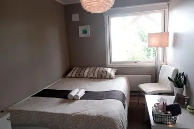 a small bedroom with a bed and a window at Adorable 1-bedroom apartment with a fantastic view - Free Parking in Trondheim