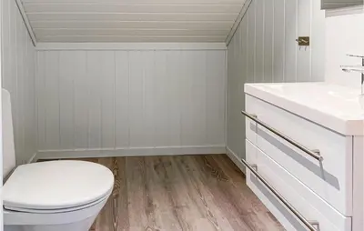 a bathroom with a toilet and a sink at Beach Front Home In Smøla With Kitchen in Smøla