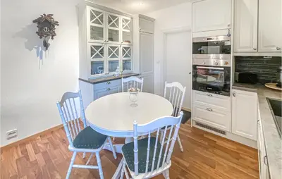 a kitchen with a white table and chairs at 1 Bedroom Nice Apartment In Hamar in Hamar