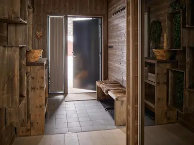 a hallway with a door in a room with wooden walls at Fjellsætra Alpegrend in Sykkylven