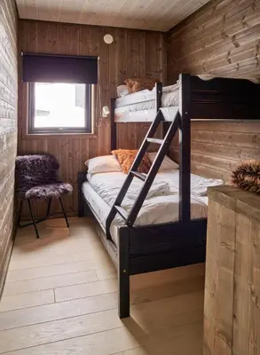 a bedroom with bunk beds in a log cabin at Fjellsætra Alpegrend in Sykkylven