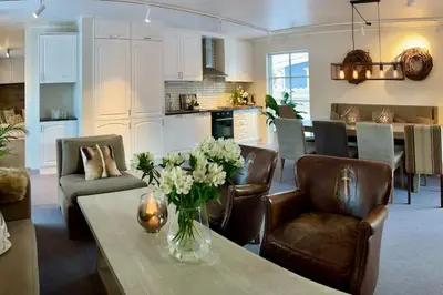 a living room with a vase of flowers on a table at New apartment near the lifts tourist center Trysil in Trysil