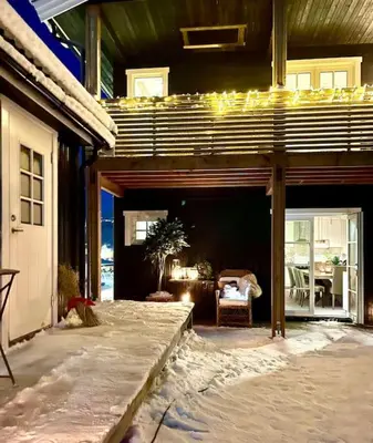 a house with a covered patio with a table and chairs at New apartment near the lifts tourist center Trysil in Trysil