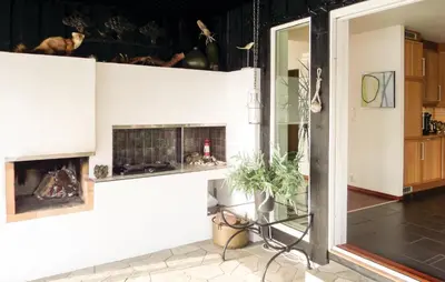 a living room with a fireplace on the wall at Gorgeous Home In Sveio With Kitchen in Sveio