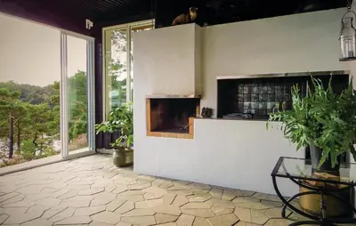a living room with a fireplace and a large window at Gorgeous Home In Sveio With Kitchen in Sveio