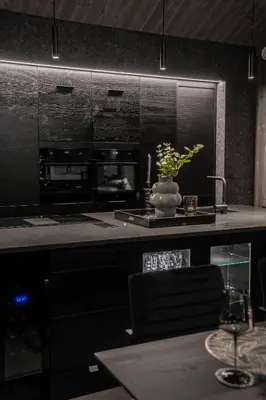 a kitchen with a counter with a vase of flowers at The Panorama Retreat - Rindabotn Cabin in Sogndal