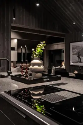 a kitchen counter with a vase with plants in it at The Panorama Retreat - Rindabotn Cabin in Sogndal