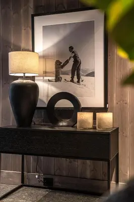 a table with a picture of a man on skis at The Panorama Retreat - Rindabotn Cabin in Sogndal