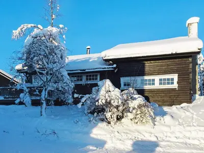 a house with a snow covered tree in front of it at 10 person holiday home in Svingvoll-By Traum in Svingvoll