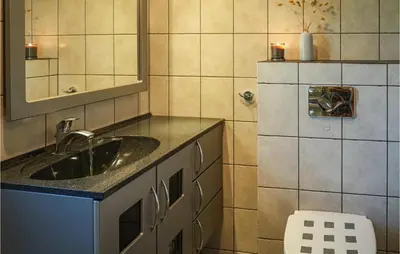a bathroom with a sink and a mirror at Beautiful Home In Hebnes With Kitchen in Hebnes