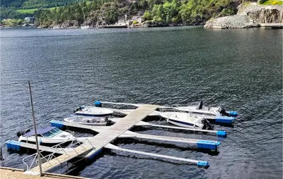 two boats are docked at a dock on a lake at Beautiful Home In Hebnes With Kitchen in Hebnes