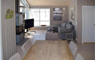 a living room with a table and a couch at Awesome Home In Rauland With Kitchen in Rauland