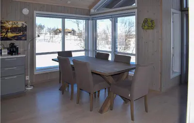 a dining room with a wooden table and chairs at Awesome Home In Rauland With Kitchen in Rauland