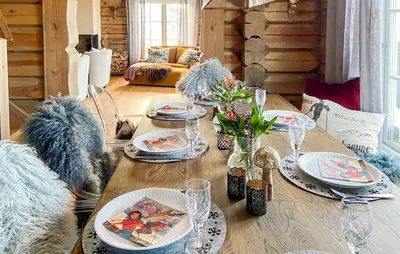 a dining room table with plates and glasses on it at Lovely Home In Rauland With Sauna in Rauland