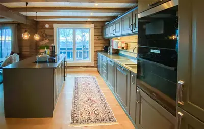 a large kitchen with a large stove top oven at Lovely Home In Rauland With Sauna in Rauland
