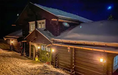 a house is covered in snow at night at Lovely Home In Rauland With Sauna in Rauland