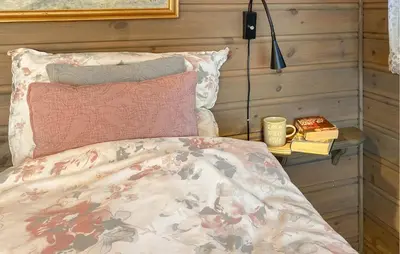 a bedroom with a bed and a table with a lamp at 3 Bedroom Gorgeous Home In Bykle in Bykle