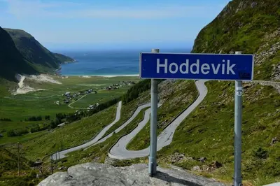 a blue street sign on the side of a road at Strøken leilighet in Åheim