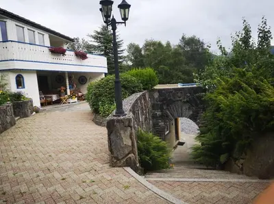 a street light sitting next to a stone bridge at Strøken leilighet in Åheim