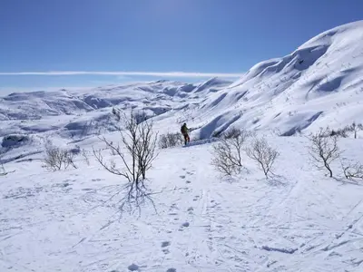 a person standing on top of a snow covered mountain at Tangen - cabin with 4 bedrooms - great nature in Norheimsund