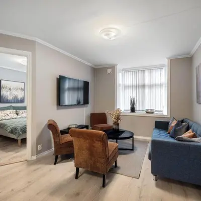 a living room with a couch and chairs and a bed at Holmboe Apartment in Bergen