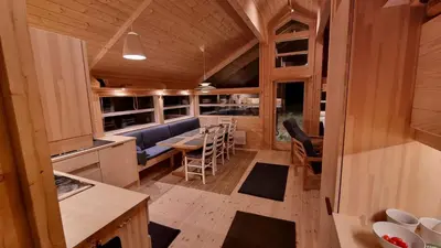 a kitchen and dining room of a tiny house at Heimstølen - Cabin at Sørbølfjell in Flå