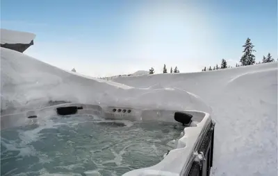 a hot tub covered in snow with snow at Stunning View In Holiday Home in Gol
