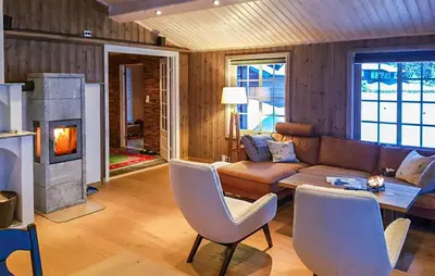 a living room with a couch and a fireplace at Cozy Home In Ulnes With Sauna in Ulnes