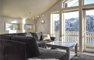 a living room with a couch and a table at 4 Bedroom Cozy Home In Fitjar in Fitjar