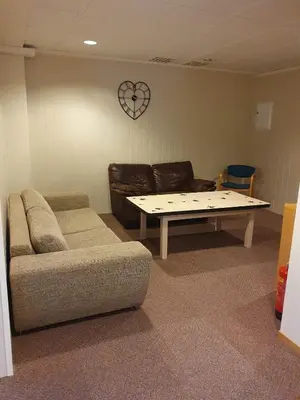 a living room with a couch and a coffee table at Leirvik i Sogn-Apartment in Leirvik