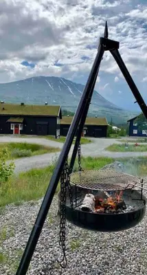 a cage with a fire in it with a mountain at Gaustablikk - ski in & out apartment - Mountain View in Gaustablikk