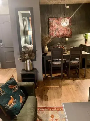 a living room with a table and a dining room at 2 leiligheter med nydelig utsikt og hotell-følelse in Beitostøl