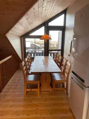 a dining room with a table and chairs at Fagertoppen 6B in Trysil