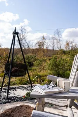a picnic table with a chair and a television at Nydelig og Moderne hytte på Kikut Geilo - 6 senger, 4 soverom og jacuzzi in Geilo