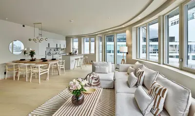 a living room with a couch and a table at Brand new and luxurious penthouse in Bergen city centre! in Bergen