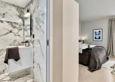 a bathroom with a shower and a bed at Brand new and luxurious penthouse in Bergen city centre! in Bergen