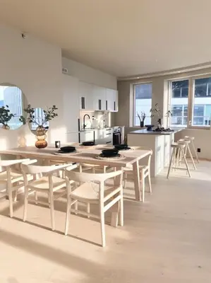 a kitchen with a table and chairs in a room at Brand new and luxurious penthouse in Bergen city centre! in Bergen