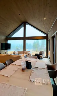 a long table in a room with a large window at Brand new cabin at Hovden cross-country skiing in Hovden