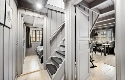 a hallway with stairs leading to a room with a table at 4 Bedroom Nice Home In Rauland in Rauland