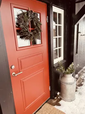 a red front door with a wreath on it at Geilo-Kikut, Ski-In, Ski-Out with Stunning Trails and Perfect Location in Geilo