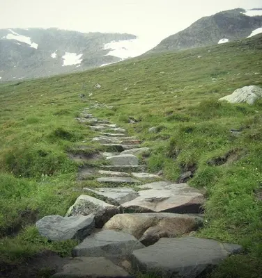 a stone path on a grassy hill with rocks at Geilo-Kikut, Ski-In, Ski-Out with Stunning Trails and Perfect Location in Geilo
