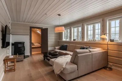 a living room with a couch and a table at Spacious detached house of 209 sqm in the heart of Geilo in Geilo
