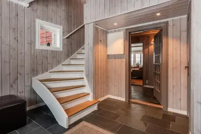 a staircase in a home with wood paneling at Spacious detached house of 209 sqm in the heart of Geilo in Geilo