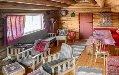 a room with a table and chairs in a cabin at Cozy Home In Vinstra With Kitchen in Vinstra